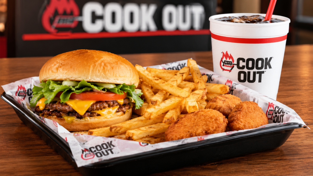 Cheeseburger tray meal with golden fries, crispy sides, and a fountain drink